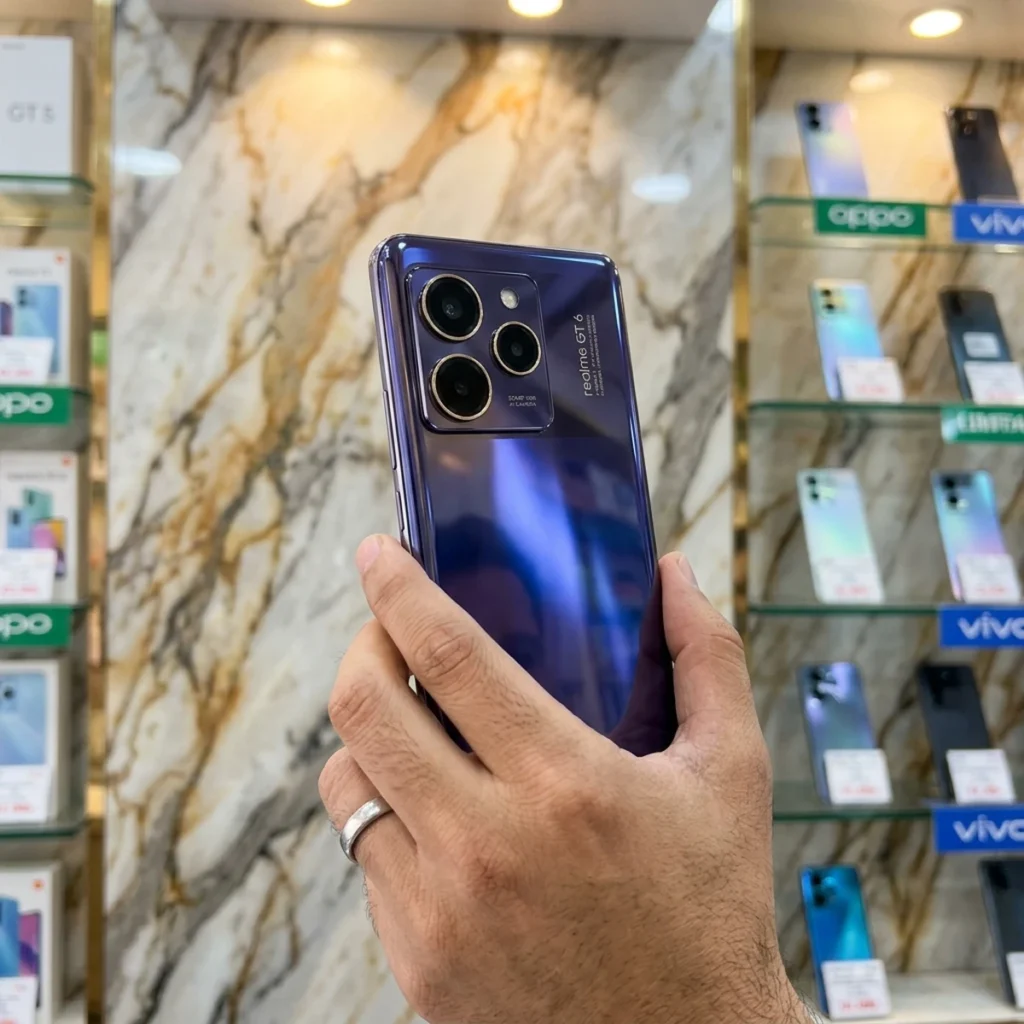 Realme GT 8 5G back panel held in hand in mobile store