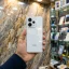 Redmi K90 5G Snow White back panel held in hand in mobile store